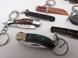 many different types of knives and key chains on the table