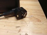 an image of a black power cord plugged into a black box