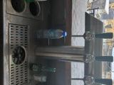 bottles of water are lined up on a counter top in a kitchen