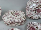 many plates and bowls that are sitting on a table