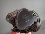 a close up of a helmet on a wooden stand
