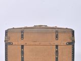 a brown suitcase sitting on a white surface