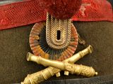 an image of a military hat with a red pom pom on it