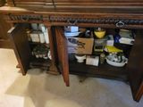 a wooden cabinet with a mirror on top of it