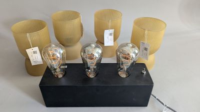 five light bulbs that are sitting on a black block