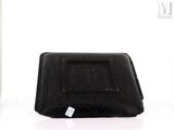 a black purse with a tag on it sitting on a table