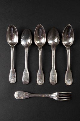 six silver spoons and a fork on a black surface