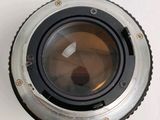 an image of a close up of a camera lens on a white surface