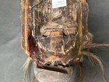 a piece of wood that has been used to make a mask