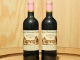 deux bouteilles de vin posées sur un tonneau