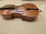 a violin that is sitting on the floor in the room