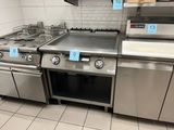 many stainless steel appliances in this kitchen with price tags on them