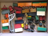 a cardboard box filled with toy trucks and other toys