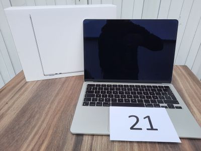a laptop computer sitting on a table next to a box