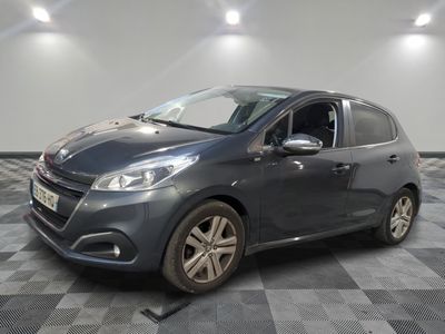 the grey car is parked on a checkered floor in the garage