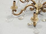 a gold chandelier with crystal beads hanging from it