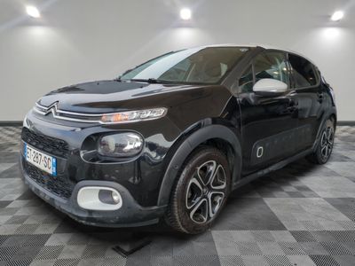 the black citrole is parked on a checkered tile floor