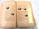 an open book with a picture of a crown on it