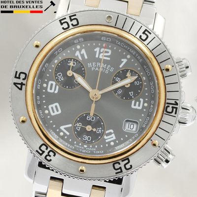 a close up of a watch on a white surface
