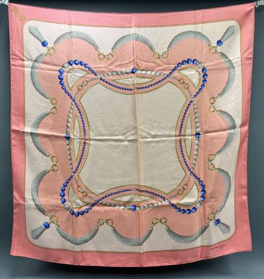 a pink and blue handkerchief hanging on a wall