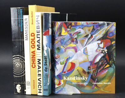 three books are stacked on top of each other on a black surface