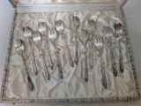 silverware in a box with a satin lining on a table