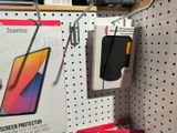 a display of cell phones on the wall in a store