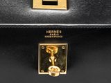 black leather briefcase with gold hardware and handle