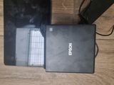 two laptops that are sitting on a wooden floor