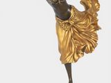 statue of a woman in a golden dress on a black base