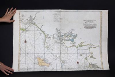 someone is holding a large map of the ocean in front of a black background