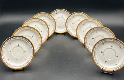 a set of six white and gold china plates with gold trim