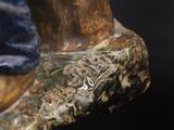 a close up of a statue of a shoe on a black surface