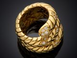 an image of a gold ring with diamonds on a black surface
