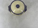 a yellow and blue pot sitting on a white surface