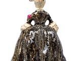 figurine of a woman in a black dress with a flower in her hair