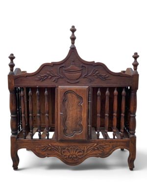a wooden bed with a carved headboard and foot board