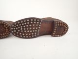 a close up of a pair of shoes with studded soles