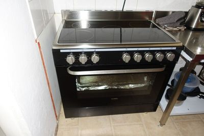 a black stove top oven sitting in a kitchen next to a counter
