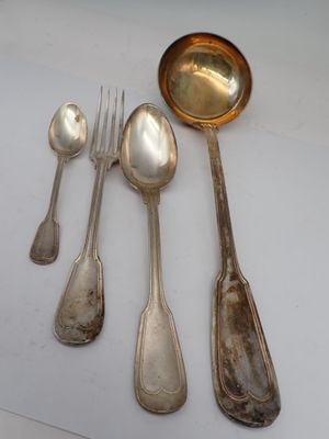 five silver spoons and two silver spoons on a table