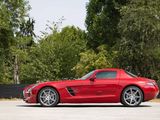 the red sports car is parked in a parking lot with trees in the background
