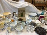 a lot of dishes and cups on the table