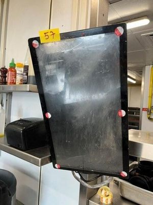 a man that is standing in a kitchen with a blackboard
