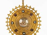 an image of a gold clock with a cross on top of it