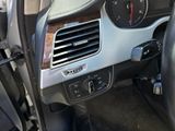 a car dashboard with a steering wheel and a clock on it