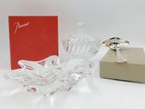a small glass bowl with a ring on it next to a box