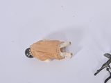 a toy sheep and a pair of scissors on a white surface