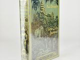 an old book with a picture of a castle and palm trees