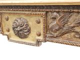 a wooden table with carvings on the top of it