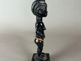 a small statue of a man with a helmet on his head